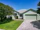 Charming home featuring a well-maintained lawn, fresh landscaping, and a two-car garage at 1157 Valley Creek Run, Winter Park, FL 32792