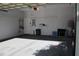 Spacious garage with grey sealed concrete floors, overhead lighting, and white walls at 1157 Valley Creek Run, Winter Park, FL 32792
