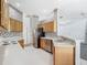 Traditional kitchen featuring wood cabinets, white countertops and tile floors at 1157 Valley Creek Run, Winter Park, FL 32792