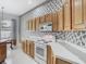 Traditional kitchen featuring wooden cabinets and white appliances at 1157 Valley Creek Run, Winter Park, FL 32792