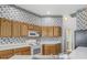 Traditional kitchen featuring wooden cabinets and white countertops at 1157 Valley Creek Run, Winter Park, FL 32792