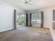 Bright living room featuring a ceiling fan and large windows and glass sliding doors at 1157 Valley Creek Run, Winter Park, FL 32792