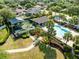 Community pool and playground surrounded by lush landscaping and palm trees at 1174 Snug Harbor Dr, Casselberry, FL 32707