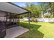 Spacious backyard with screened patio, grassy lawn, and fenced perimeter at 1174 Snug Harbor Dr, Casselberry, FL 32707
