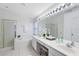 Bright bathroom with double vanity, tub, shower, and decorative lighting at 1174 Snug Harbor Dr, Casselberry, FL 32707
