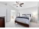 Bright bedroom features a ceiling fan, neutral carpet, and ensuite bathroom at 1174 Snug Harbor Dr, Casselberry, FL 32707