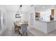 Dining area featuring a stylish light fixture, view into the kitchen, and neutral colors at 1174 Snug Harbor Dr, Casselberry, FL 32707