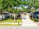 Charming single-story home with a well-maintained lawn, mature trees, and a two-car garage at 1174 Snug Harbor Dr, Casselberry, FL 32707