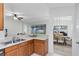 Open kitchen featuring wood cabinets, breakfast bar, and a view into the living and dining areas at 1174 Snug Harbor Dr, Casselberry, FL 32707