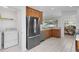 Well-equipped kitchen with stainless steel appliances, wood cabinetry, and adjacent laundry area at 1174 Snug Harbor Dr, Casselberry, FL 32707