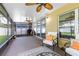 Enclosed patio with outdoor seating, ceiling fans, and sliding glass doors at 1174 Snug Harbor Dr, Casselberry, FL 32707