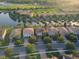 Aerial view features single-Gathering homes near a pond and green spaces in a well-maintained neighborhood at 11962 Autumn Fern Ln, Orlando, FL 32827