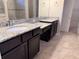Bathroom featuring granite countertops, double sinks, and elegant cabinets at 11962 Autumn Fern Ln, Orlando, FL 32827