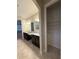 Bright bathroom with double sinks, granite counters, tile floors, and closet at 11962 Autumn Fern Ln, Orlando, FL 32827