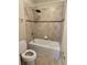 Well-lit bathroom featuring a shower-tub combo with a modern shower head and tiled walls at 11962 Autumn Fern Ln, Orlando, FL 32827