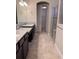 Well-lit bathroom boasting dual sinks with granite countertops and a glass-enclosed shower at 11962 Autumn Fern Ln, Orlando, FL 32827