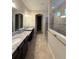 Spacious bathroom featuring double granite vanity and large glass enclosed shower at 11962 Autumn Fern Ln, Orlando, FL 32827