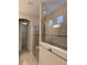 Walk-in shower boasting tile walls, glass door, and convenient built-in bench at 11962 Autumn Fern Ln, Orlando, FL 32827
