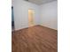 Bright bedroom featuring wood-look floors and a doorway to an open closet at 11962 Autumn Fern Ln, Orlando, FL 32827
