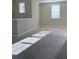 Bright bonus room with plush carpet and natural light streaming through the windows at 11962 Autumn Fern Ln, Orlando, FL 32827