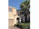 Charming two-story home showcases a tile roof, an arched entryway, manicured landscaping, and a two-car garage at 11962 Autumn Fern Ln, Orlando, FL 32827