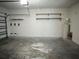 Spacious garage with concrete floor, white walls, and overhead storage racks at 11962 Autumn Fern Ln, Orlando, FL 32827