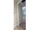 Neutral hallway leading to a carpeted bedroom and featuring updated trim at 11962 Autumn Fern Ln, Orlando, FL 32827