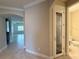 Hallway with a wine room door and view to the living room and bathroom at 11962 Autumn Fern Ln, Orlando, FL 32827