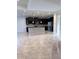 Spacious kitchen with large island, dark cabinets, stainless steel appliances, and granite countertops at 11962 Autumn Fern Ln, Orlando, FL 32827