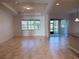 Inviting living room with tiled floors, recessed lighting, and sliding glass doors that open to the outdoor area at 11962 Autumn Fern Ln, Orlando, FL 32827