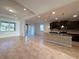 Open-concept living area with kitchen island, dark wood cabinets, and natural light, perfect for modern living and entertaining at 11962 Autumn Fern Ln, Orlando, FL 32827