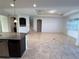 Spacious living room featuring tiled floors, recessed lighting, an office nook, and stair access to the second floor at 11962 Autumn Fern Ln, Orlando, FL 32827