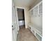 Bright mudroom with storage bench, coat hooks, and direct access to the laundry room for added convenience at 11962 Autumn Fern Ln, Orlando, FL 32827