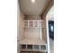 Well-organized mudroom boasts built-in shelves, coat hooks, and a seating bench for convenient storage and organization at 11962 Autumn Fern Ln, Orlando, FL 32827