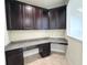 Office nook featuring dark wood cabinetry, granite countertops, and tiled floors at 11962 Autumn Fern Ln, Orlando, FL 32827