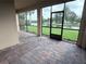 Enclosed patio with brick floor, screens, and a view of the canal at 11962 Autumn Fern Ln, Orlando, FL 32827