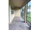 Enclosed patio with brick floor, screens, and view of the garden at 11962 Autumn Fern Ln, Orlando, FL 32827