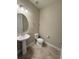 Stylish powder room featuring pedestal sink, modern fixtures, and neutral tones, creating a clean and welcoming space at 11962 Autumn Fern Ln, Orlando, FL 32827