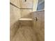 Shower with bench seat featuring tiled walls and updated fixtures at 11962 Autumn Fern Ln, Orlando, FL 32827
