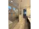 Bright bathroom shower featuring frameless glass door and tiled walls at 11962 Autumn Fern Ln, Orlando, FL 32827