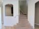 A carpeted staircase with white walls and an arched entryway at 11962 Autumn Fern Ln, Orlando, FL 32827
