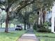 A sidewalk view with trees lining the street at 11962 Autumn Fern Ln, Orlando, FL 32827