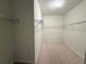 Empty walk-in closet with wire shelves and plush neutral carpeting at 11962 Autumn Fern Ln, Orlando, FL 32827