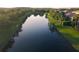 Aerial view of lake with trees lining the water at 11962 Autumn Fern Ln, Orlando, FL 32827