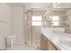 Bright bathroom with glass enclosed shower, a white vanity, and neutral tile at 126 Knights Hollow Dr, Apopka, FL 32712