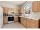 Kitchen area with a large arched window, tile floors and plenty of countertop space at 126 Knights Hollow Dr, Apopka, FL 32712