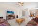 Open-concept living room, with media center, sofas and ceiling fan at 126 Knights Hollow Dr, Apopka, FL 32712
