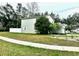 View of the backyard, featuring a vinyl fence, lush lawn and landscaping at 1309 Harms Way, Port Orange, FL 32129
