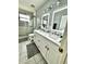 Modern bathroom featuring double sinks, decorative tile floors, and glass enclosed shower at 1309 Harms Way, Port Orange, FL 32129