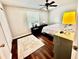 Bedroom with hardwood floors, a window and a bed with white linens at 1309 Harms Way, Port Orange, FL 32129